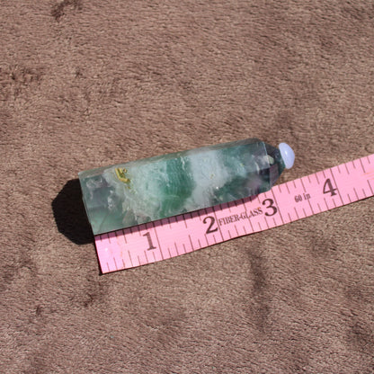 Rainbow Fluorite tower showcasing vibrant green and purple hues, perfect for crystal enthusiasts