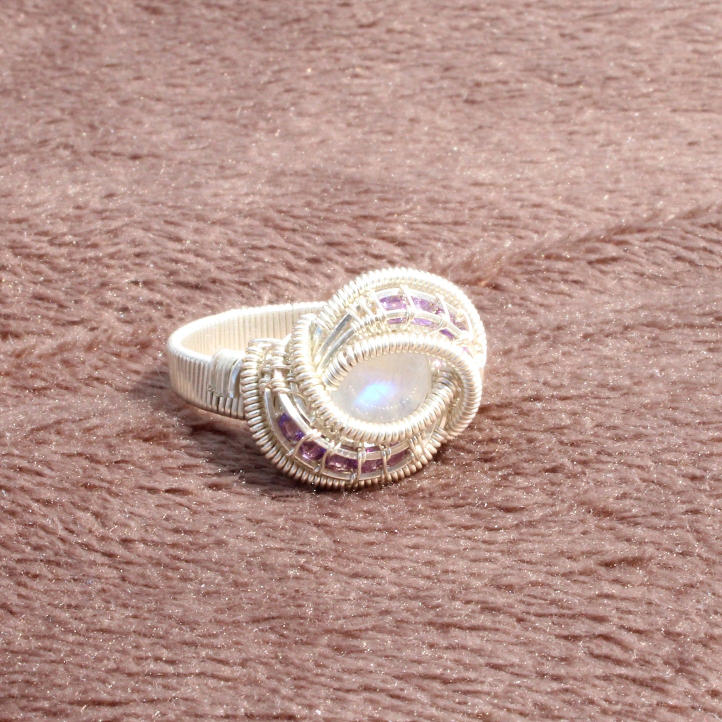 Rainbow moonstone and amethyst sterling silver ring with intricate wire design and sparkling gemstones