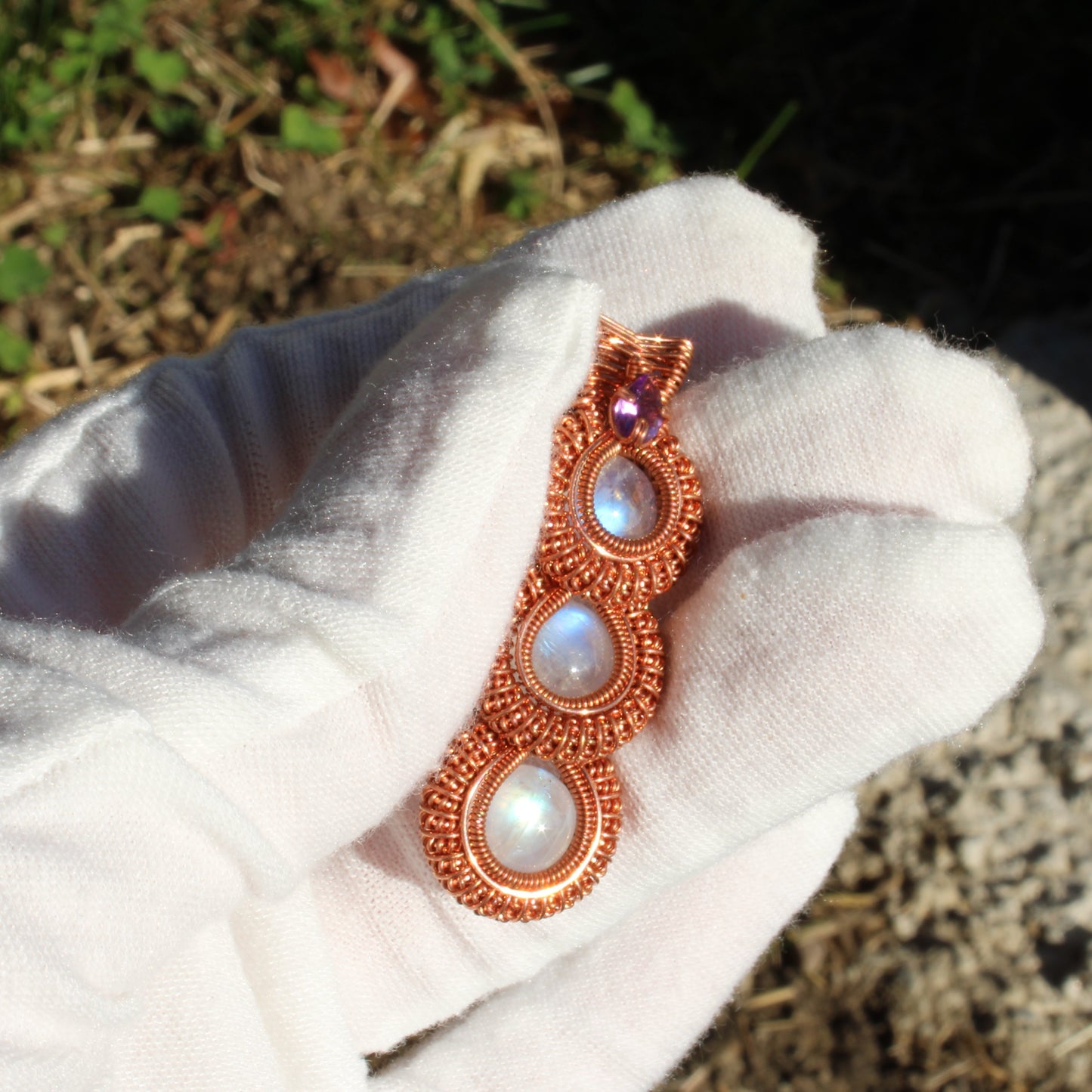 Rainbow moonstone copper pendant featuring three shimmering stones in a handcrafted design