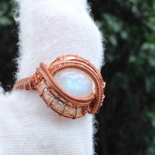Rainbow Moonstone copper ring with intricate wire wrapping and sparkling accents for unique jewelry lovers