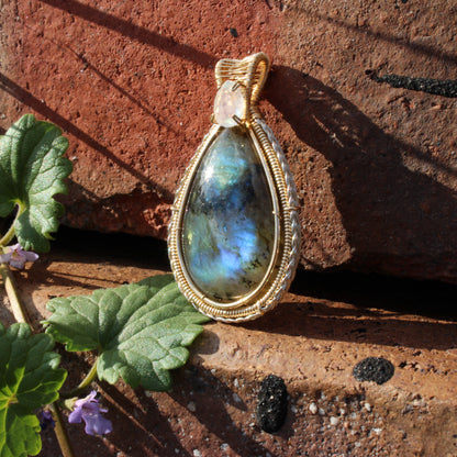 Rainbow Moonstone & Labradorite 14k Gold fill pendant elegantly displayed on textured stones