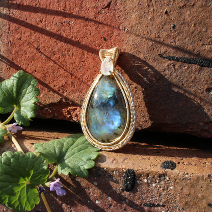 Rainbow Moonstone & Labradorite 14k Gold fill pendant on rustic stone background with greenery