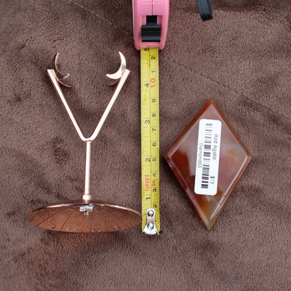 Red Agate Diamond crystal from Different Branches LLC displayed next to a tape measure and metal stand