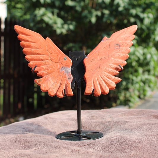 Red Jasper Owl Wings crystal sculpture on a black metal stand by Different Branches LLC