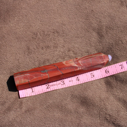 Red jasper tower with natural patterns, measuring approximately six inches in length