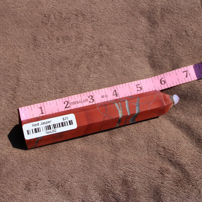 Red jasper tower with smooth surface and natural patterns for decorative or healing purposes
