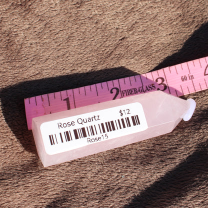 Natural Rose Quartz tower priced at twelve dollars, showcasing its soft pink color and smooth surface