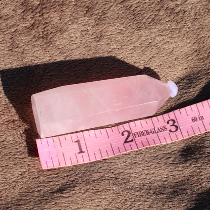 Rose Quartz tower showcasing its light pink hue and smooth facets, perfect for crystal healing