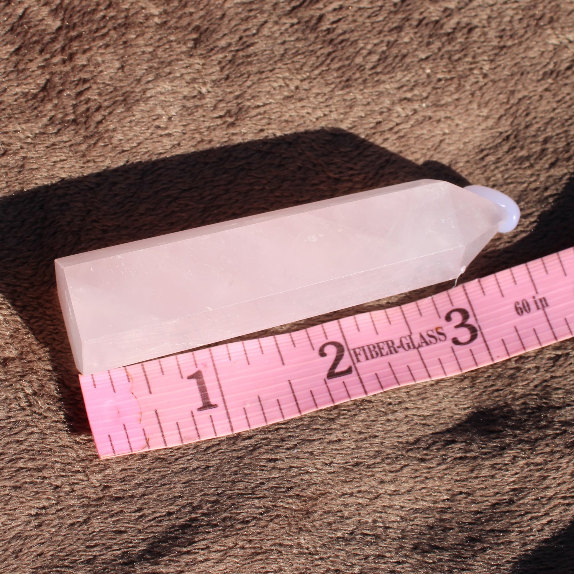 Rose Quartz tower with a polished surface, measuring approximately 2 inches in height, ideal for decor or healing