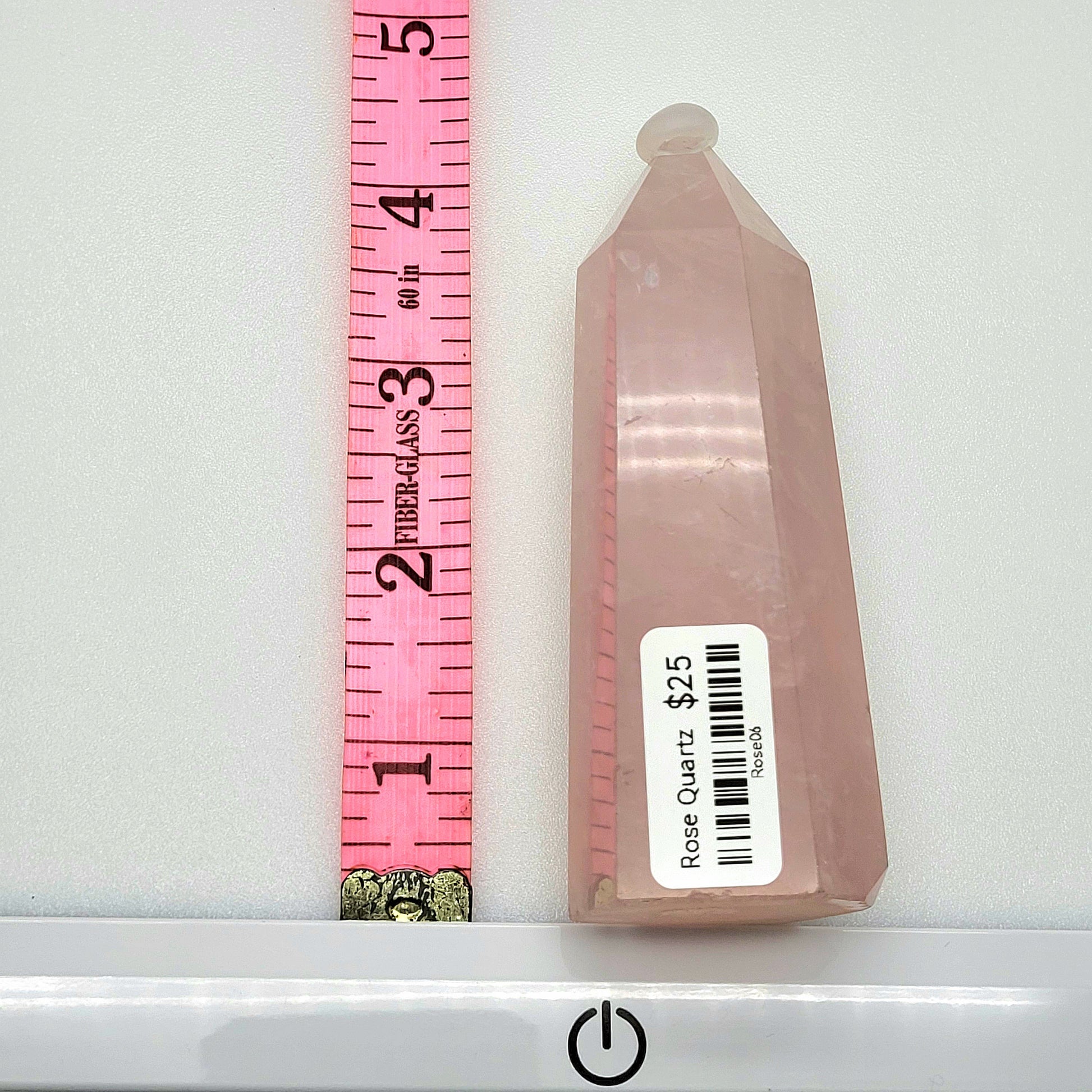 Rose Quartz Towers shown next to a ruler for size comparison, elegantly crafted with a soft pink hue