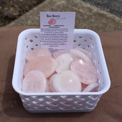 Smooth polished Rose Quartz Worry Stone crystals in white basket with informational card
