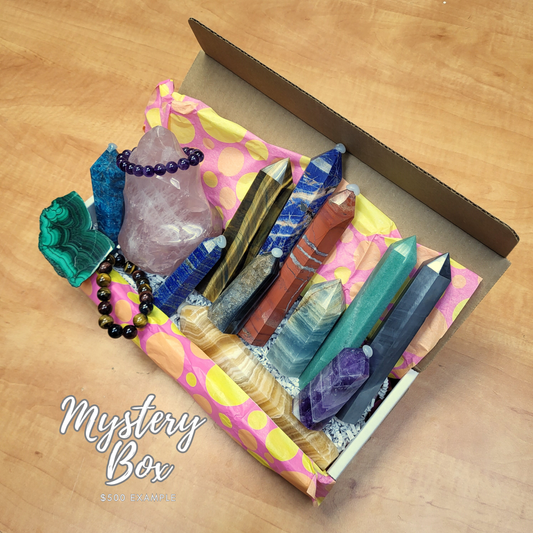 Crystal mystery box picked by sarah featuring assorted polished crystals and gemstones arranged in a colorful box