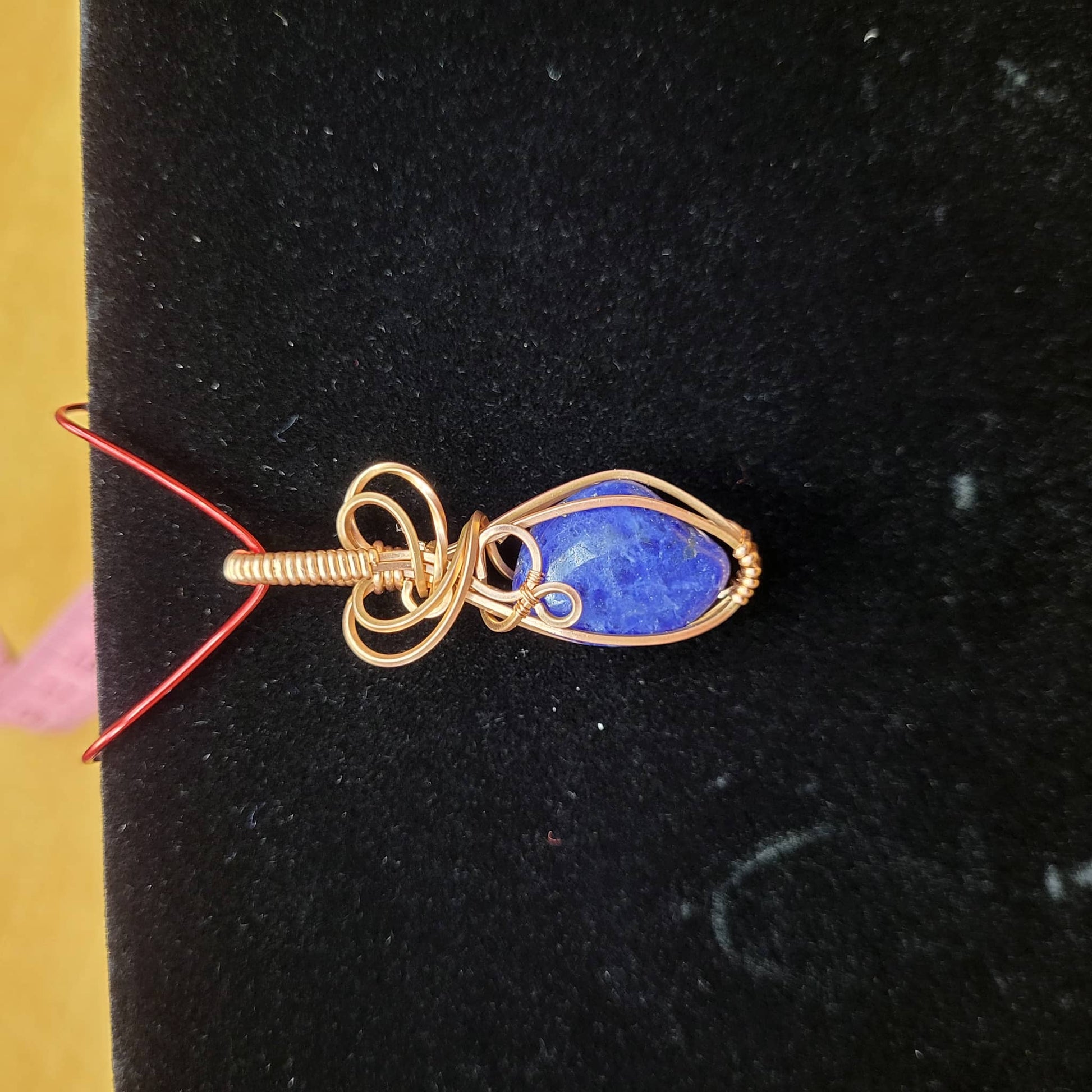 Handcrafted Sodalite Pendant Wrapped in Gold Wire for Unique Jewelry Statement