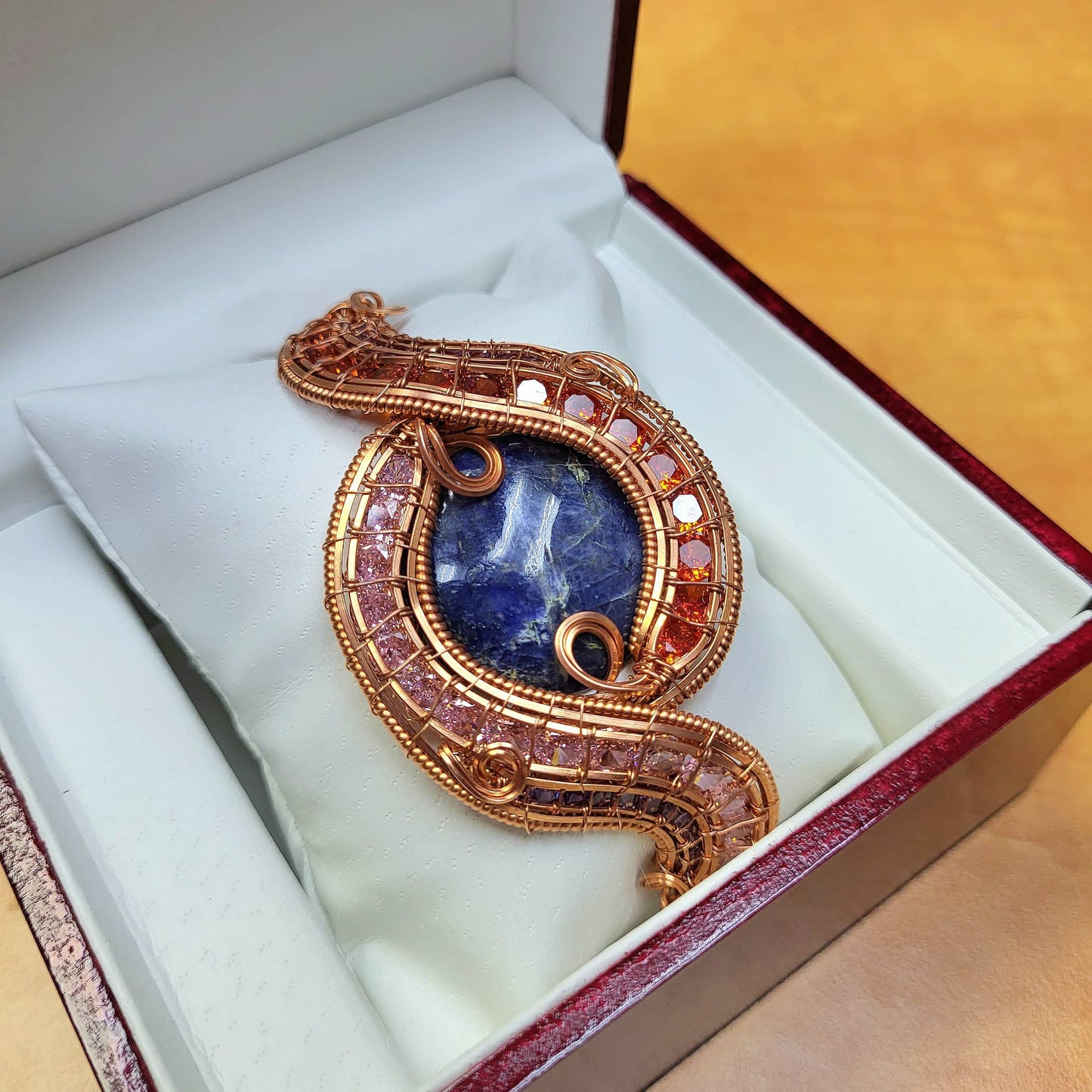Elegant Sodalite raw copper bracelet displayed in a red gift box with soft padding