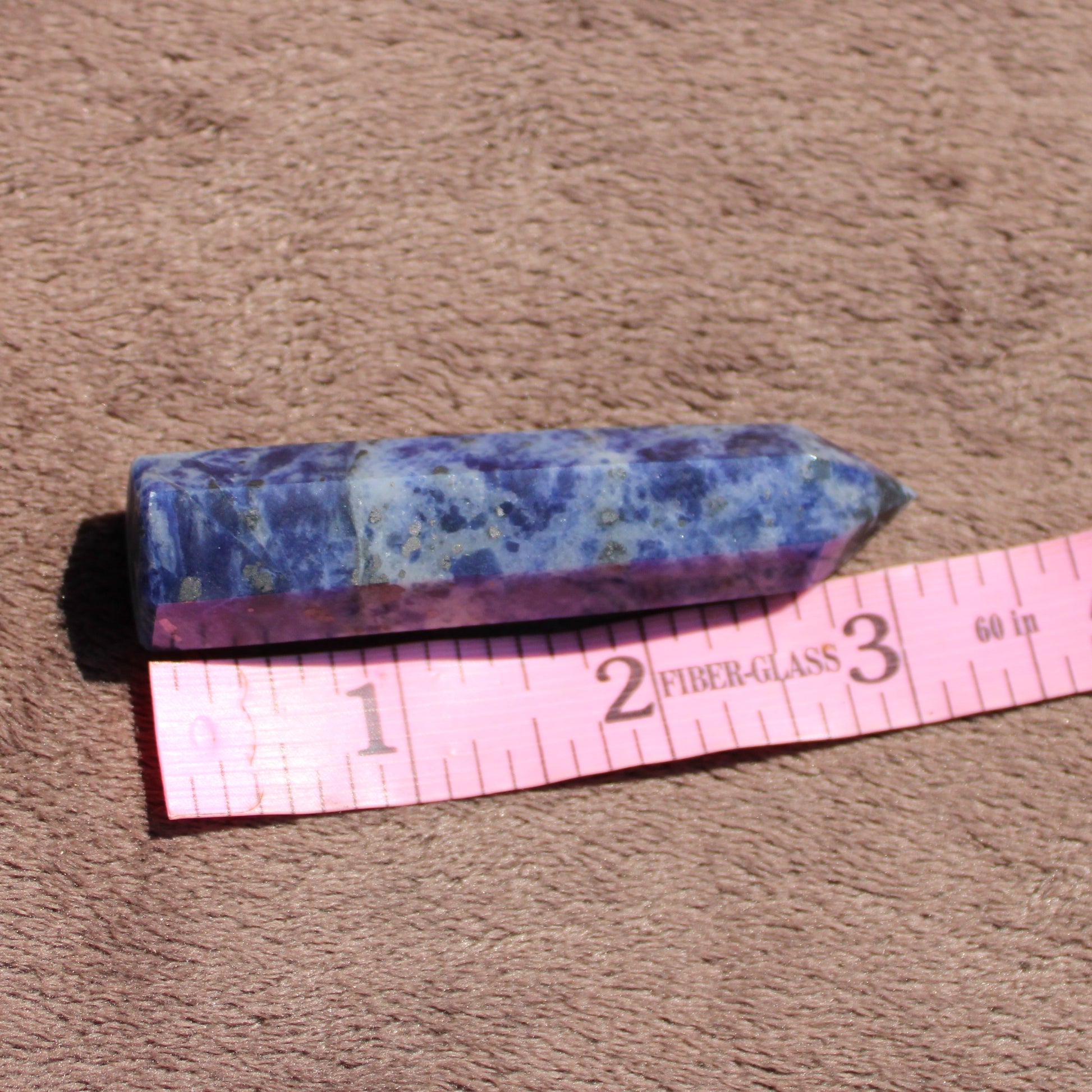 Sodalite tower crystal with deep blue hues, measuring approximately 6 inches long