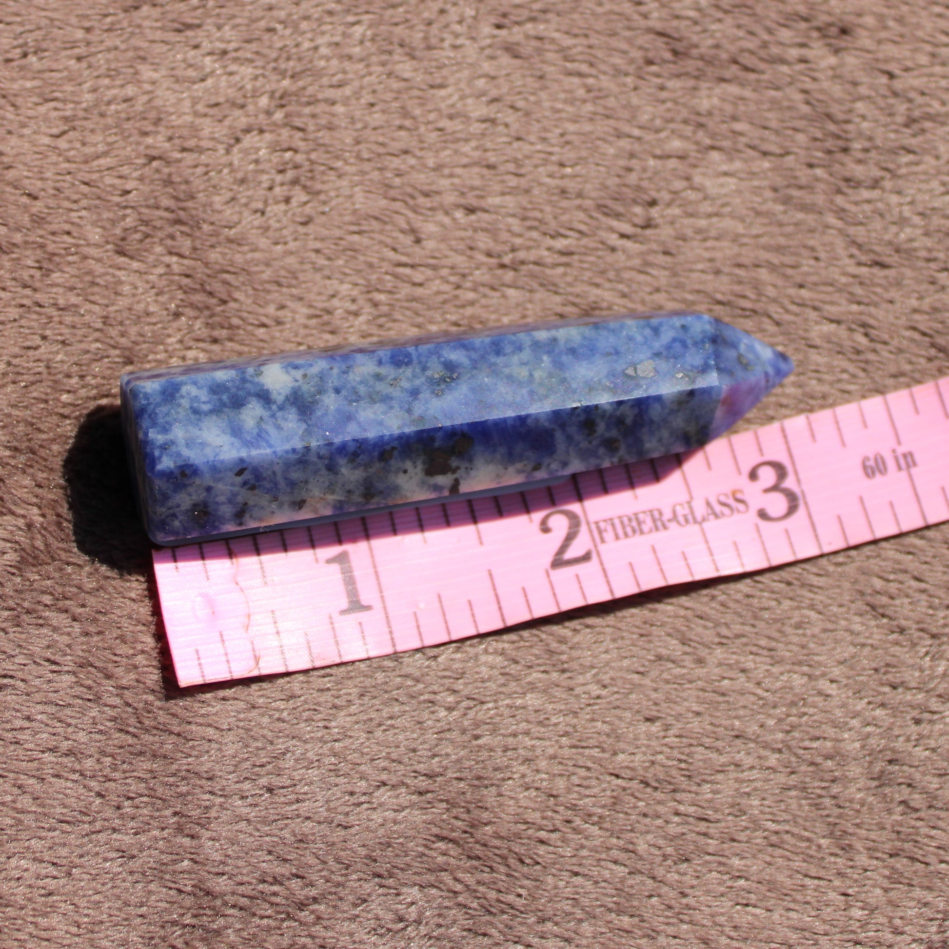 Sodalite tower by Different Branches LLC showcasing deep blue hues with natural mineral patterns