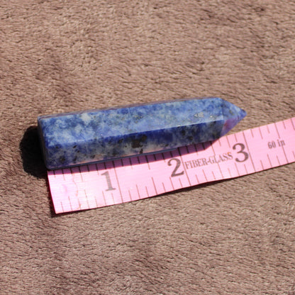 Sodalite tower by Different Branches LLC showcasing deep blue hues with natural mineral patterns