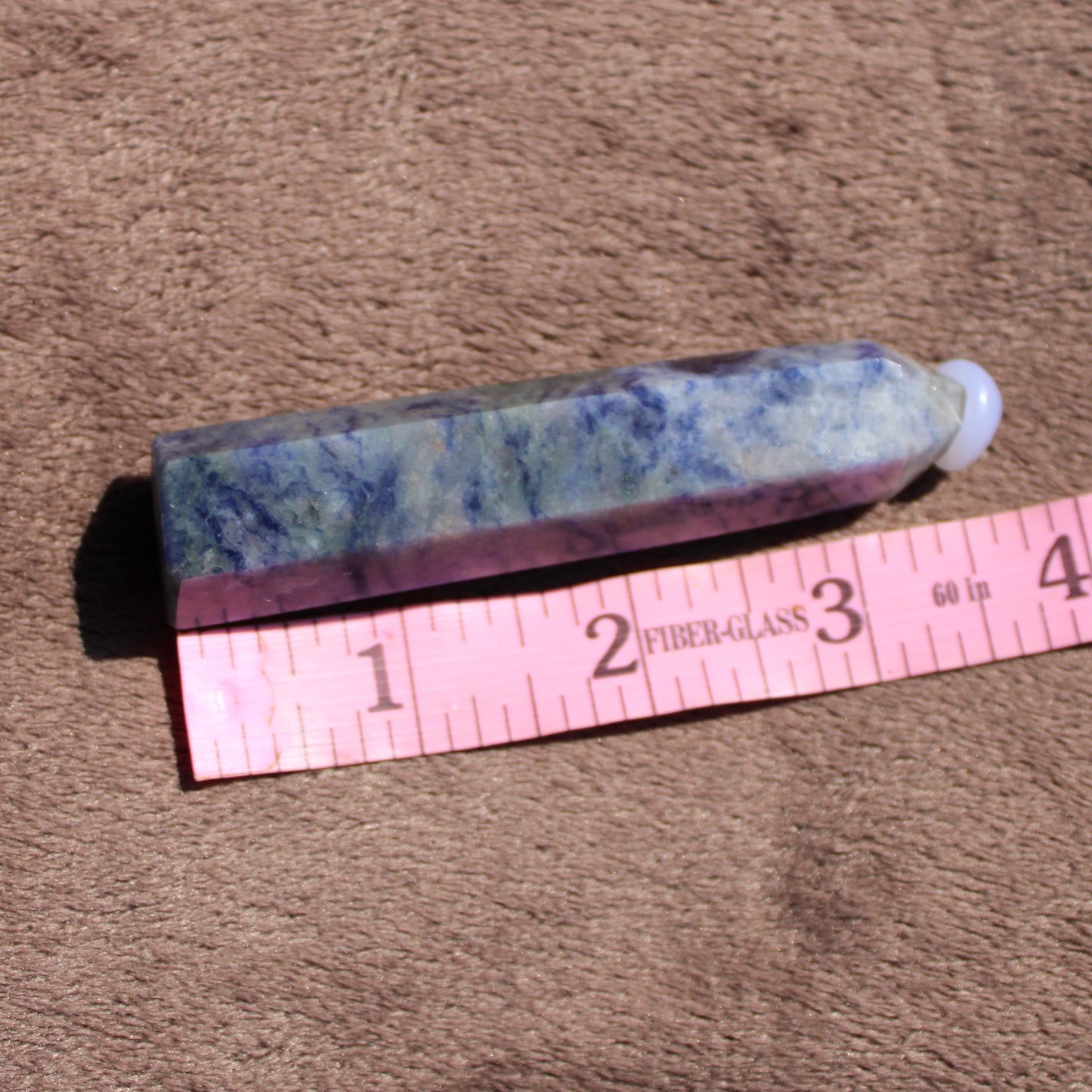 Sodalite tower crystal showcasing rich blue and purple hues with a smooth finish for decorative use