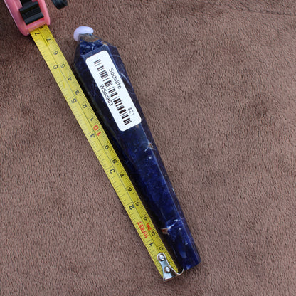 Sodalite wand crystal from Different Branches LLC placed next to a yellow measuring tape on brown fabric