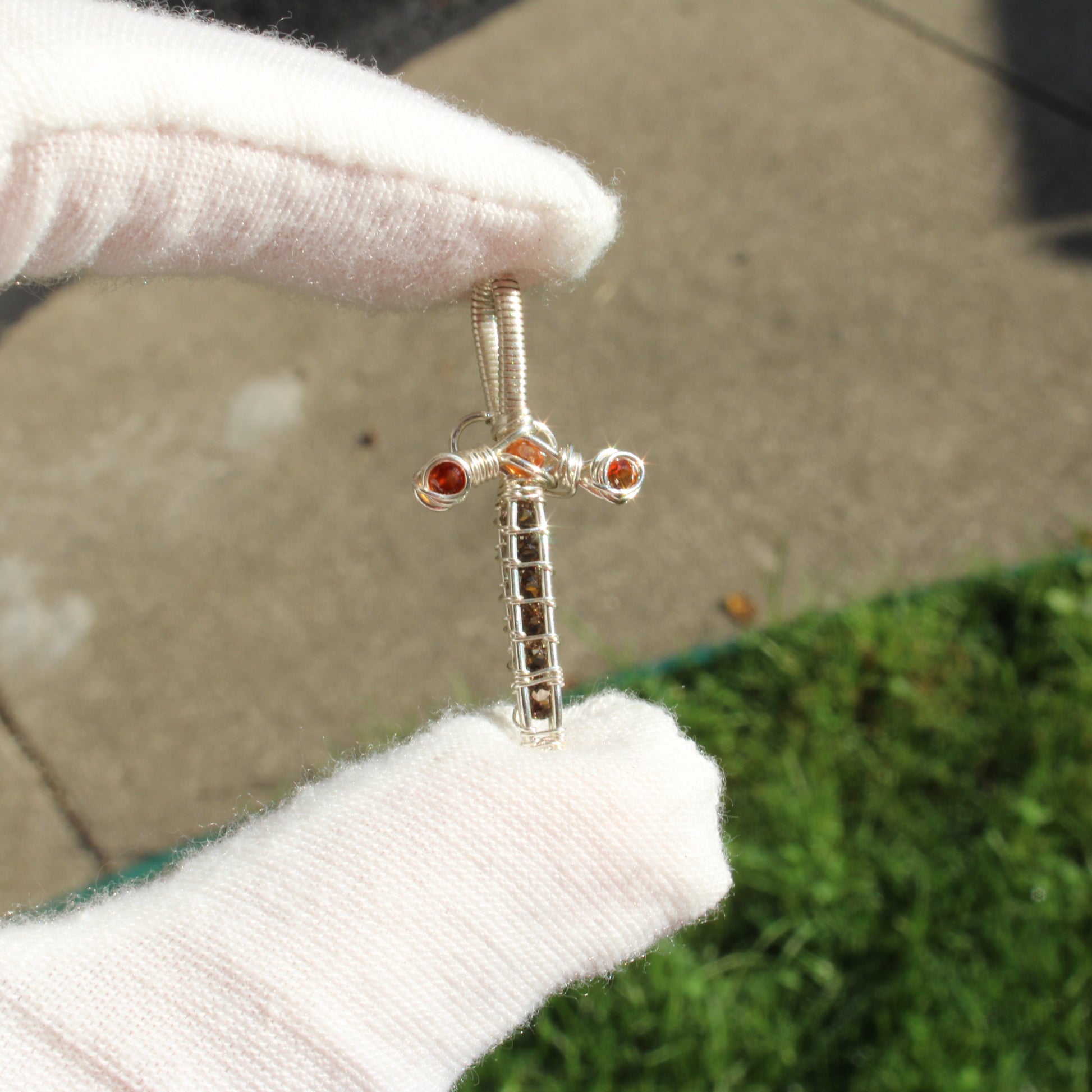 Sterling silver sword pendant adorned with smokey quartz and garnet gemstones
