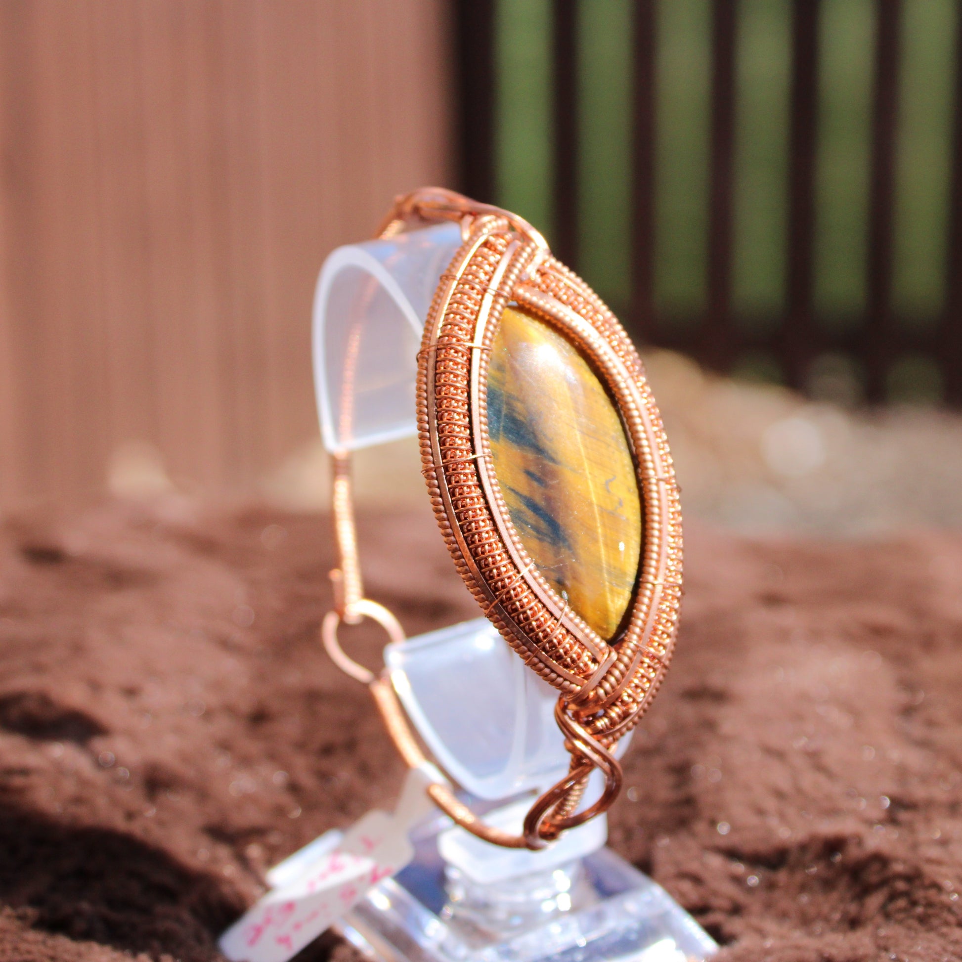 Tiger Eye Bracelet in a unique wire wrap design, showcasing the stone's natural beauty and luster