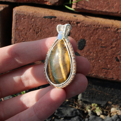 Tiger eye, Ethiopian opal sterling silver pendant with intricate wire wrapping, perfect for elegant jewelry displays