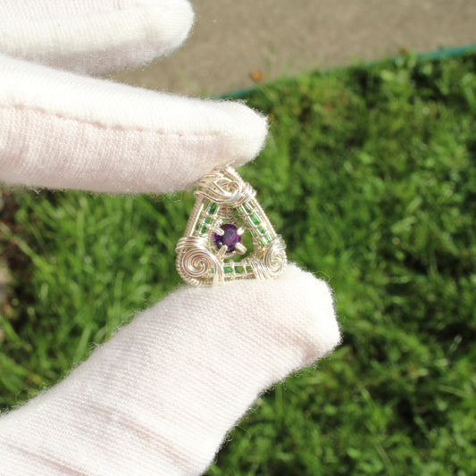Handcrafted sterling silver pendant featuring tsavorite and amethyst in a unique design