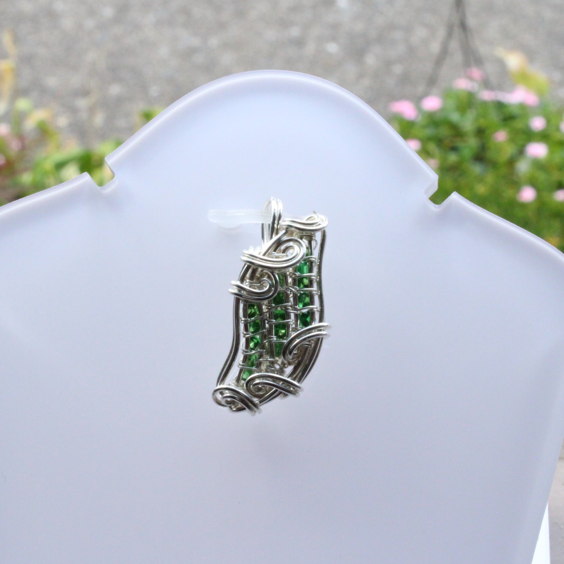 Elegant Tsavorite Sterling Silver Pendant featuring intricate wire designs and vibrant green gemstones