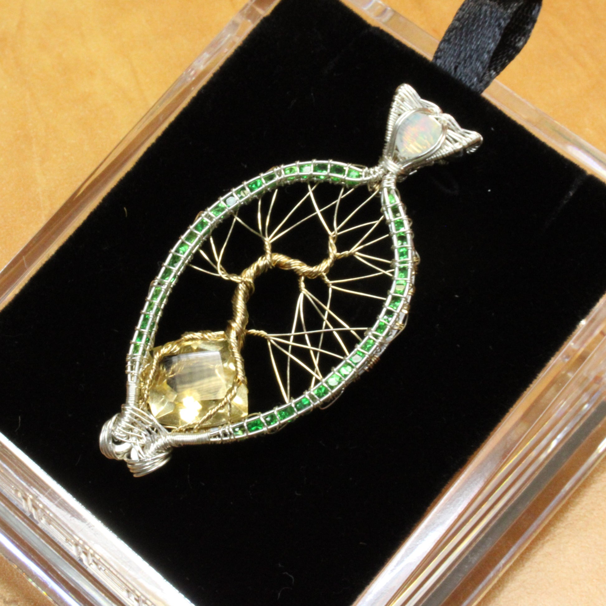 Handcrafted Tsavorite tree of life pendant featuring intricate wirework and vibrant green stones