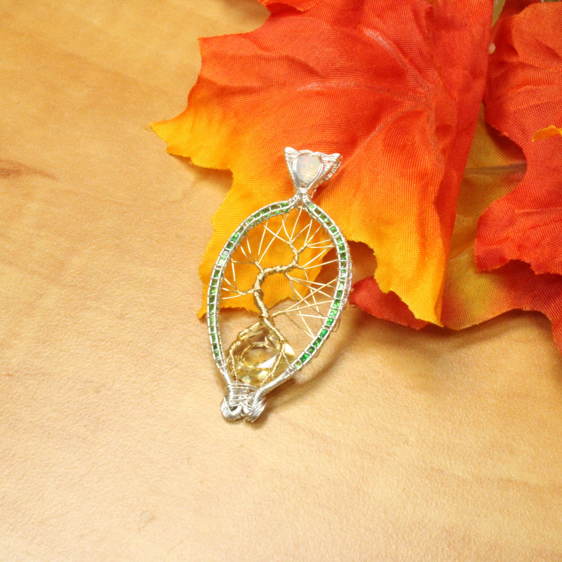 Elegant Tsavorite tree of life pendant with intricate design and a yellow gemstone centerpiece