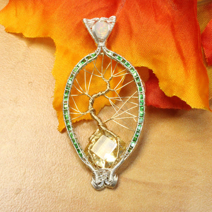 Unique Tsavorite tree of life pendant with intricate wire design and golden gemstone accents