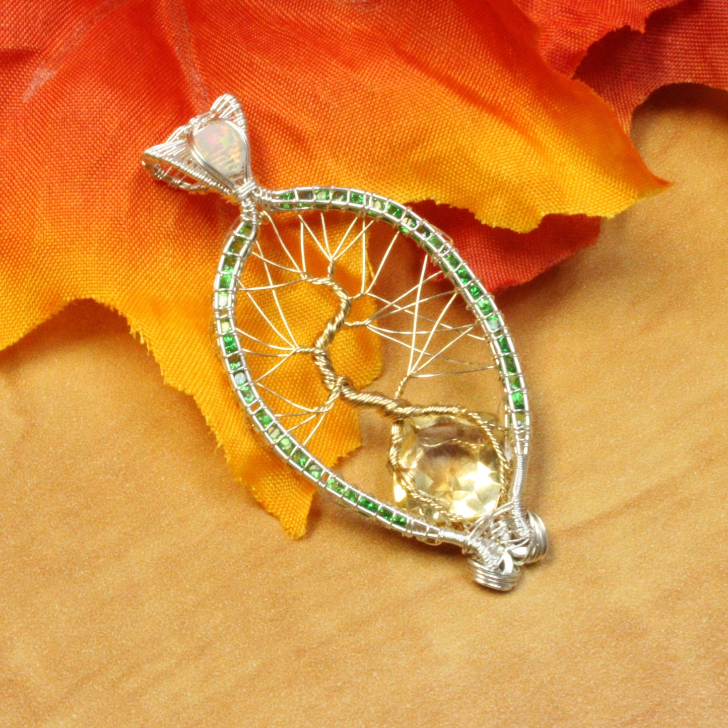 Elegant Tsavorite tree of life pendant with intricate silver detailing and a central gem