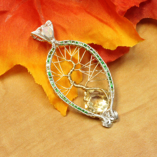 Elegant Tsavorite tree of life pendant with intricate silver detailing and a central gem