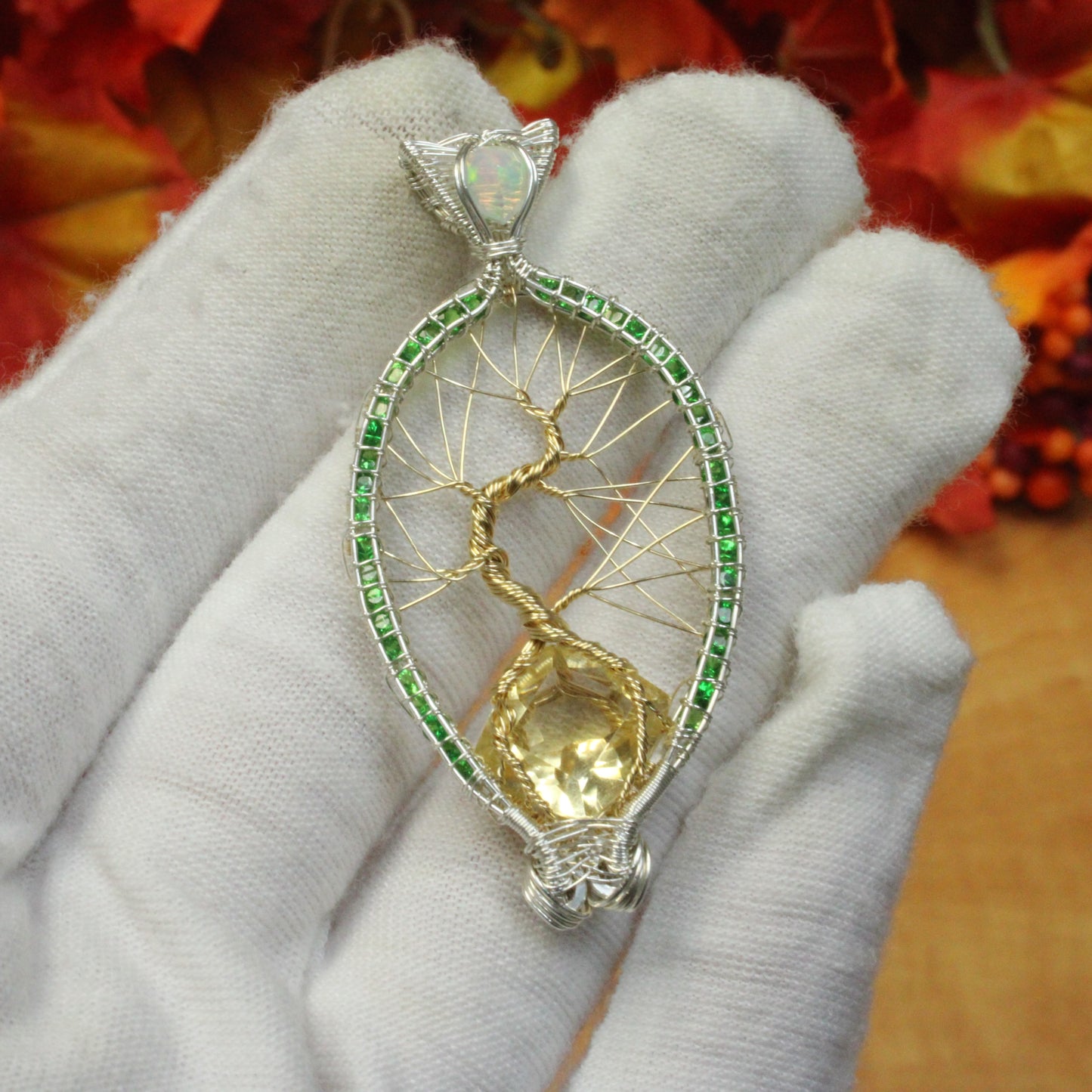 Tsavorite tree of life pendant with intricate gold wire design and a central gemstone