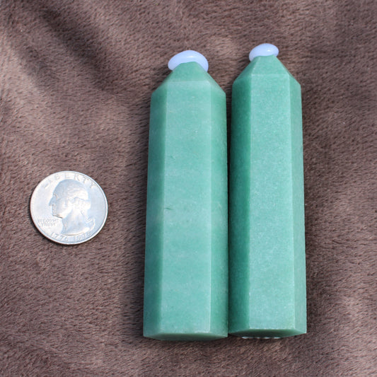 Two polished Green Aventurine Tower crystals standing next to a US quarter for size comparison