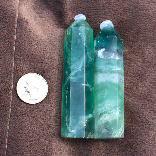 Green Fluorite Tower crystal with pointed tips next to a coin for size reference by Different Branches LLC